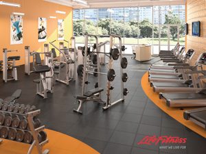 Top Corporate Room Life Fitness big gym with orange accents and a variety of machines