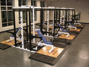 JR Tucker high school work out space open floor gym with weight benches in the center of the room