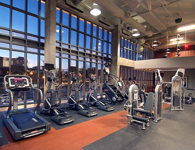 Brand new fitness area with different equipment and large windows