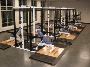 open floor gym with weight benches in the center of the room