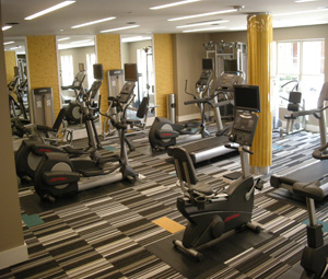 carpeted flooring with gym equipment strategically placed throughout